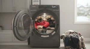 A large-capacity gas dryer loaded with bulky winter coats and family bedding, demonstrating high volume capacity.