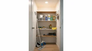flat mop vs spin mop for small apartments shown stored neatly in a tight hallway closet